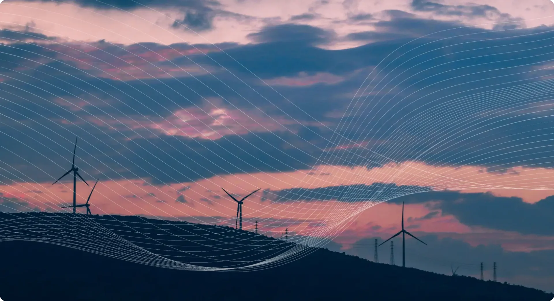 Windmills on a hill and a pink sky with clouds