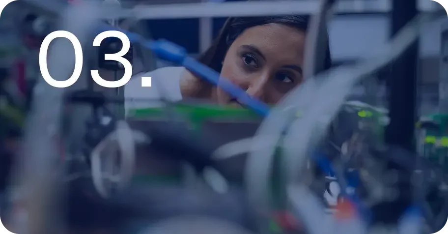 Person examining technical equipment with the number 03. displayed in the foreground.