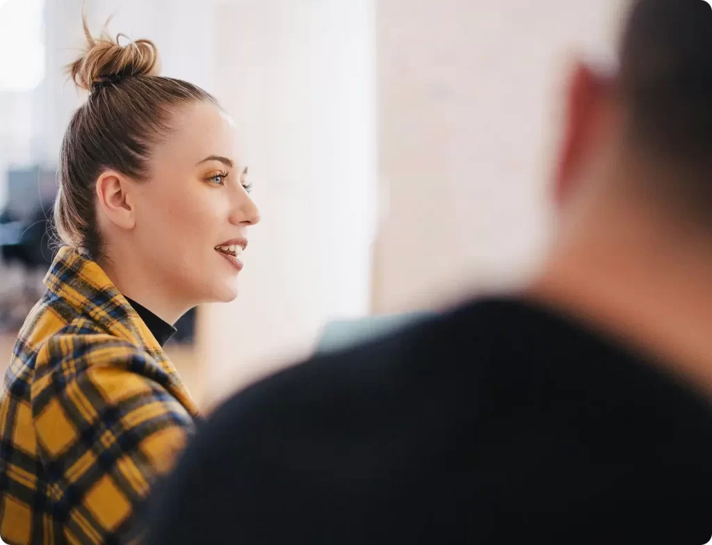 Woman during a team meeting in a bright office.